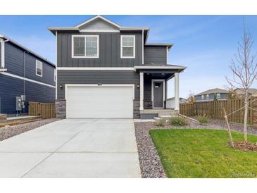 Two-story home with gray siding and a white garage door at 1916 Pinnacle Ave, Lochbuie, CO 80603