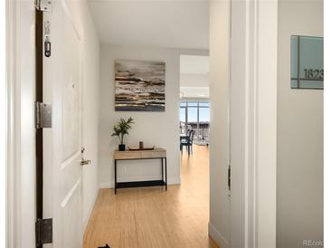 Bright entryway with hardwood floors and view into the living area at 2001 Lincoln St # 1823, Denver, CO 80202