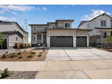 Two-story house with two-car garage and landscaped front yard at 3442 N Gold Bug Ct, Aurora, CO 80019