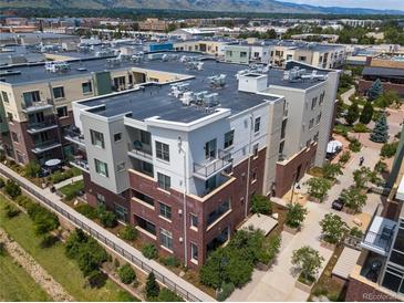 Aerial view of a modern condo building with a pool and mountain views at 3301 Arapahoe Ave # 214, Boulder, CO 80303