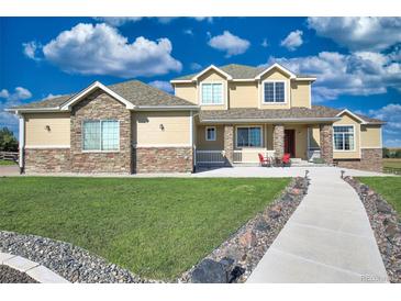 Two-story house exterior with stone and siding at 41860 Muirfield Loop, Elizabeth, CO 80107