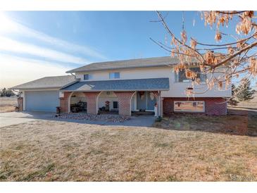 Ranch style home with brick accents and attached two-car garage at 3601 Sunrise Ln, Brighton, CO 80603