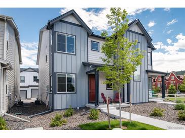 Two-story home with gray siding and red door at 12772 Boggs St, Parker, CO 80134