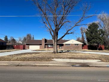 Ranch style home with large yard and circular driveway at 6601 E Exposition Ave, Denver, CO 80224