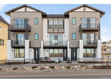 Modern 3-unit townhome development with balconies and landscaped front yards at 10860 Lyric St, Lone Tree, CO 80134