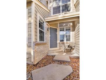 Inviting front entrance with gray door and small patio at 7373 E Iowa Ave # 1101, Denver, CO 80231