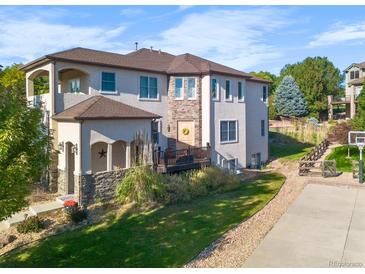 Two-story home with stone accents and deck at 10215 W Wesley Dr, Lakewood, CO 80227