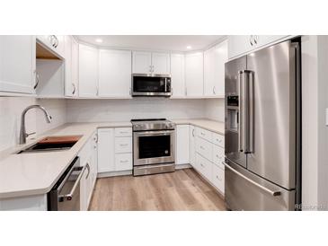 Modern kitchen with stainless steel appliances and white cabinets at 3144 S Wheeling Way # 107, Aurora, CO 80014
