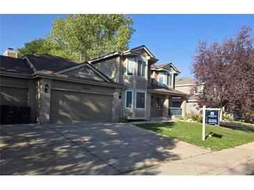 Two-story home with attached garage and landscaping at 21064 E Crestline Cir, Centennial, CO 80015