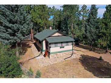 Secluded mountain cabin nestled in a wooded lot with a spacious yard at 5673 Santa Clara Rd, Indian Hills, CO 80454