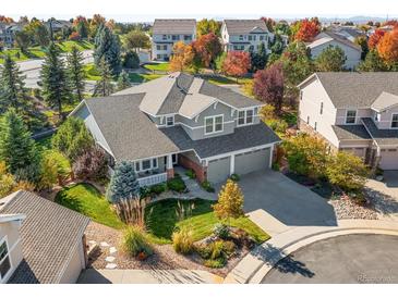 Aerial view of a two-story house with a landscaped yard and driveway at 6294 S Ouray Ct, Aurora, CO 80016