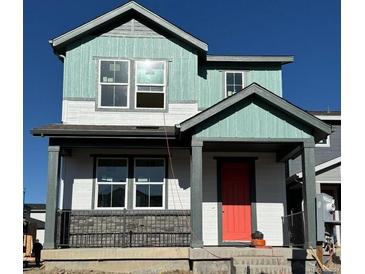 Two-story home with teal and white siding, a red door, and a gray metal railing at 21294 E 63Rd Dr, Aurora, CO 80019