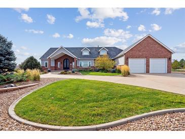 Brick and shingle house with a two car garage at 29850 E 167Th Pl, Brighton, CO 80603