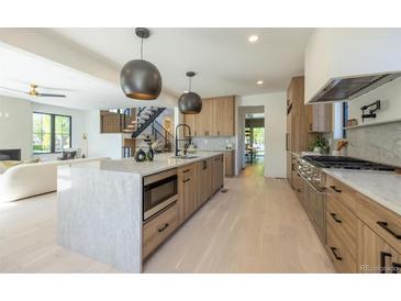 Modern kitchen with large island and stainless steel appliances at 2200 Newton St, Denver, CO 80211