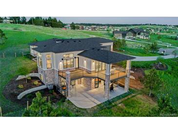 Luxury home with expansive backyard and deck, offering stunning views at 2937 Hidden Den Ct, Franktown, CO 80116