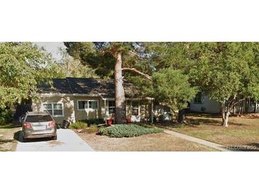 Ranch style home with mature landscaping and driveway at 2906 S Fairfax St, Denver, CO 80222