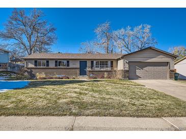 Ranch style home with attached garage and landscaped yard at 3417 S Chester Ct, Denver, CO 80231