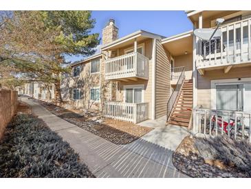 Exterior view of condo building showing walkway, stairs, and private entrance at 4400 S Quebec St # 207X, Denver, CO 80237