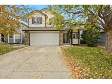 Two-story house with attached garage and landscaped lawn at 13935 Harrison Dr, Thornton, CO 80602