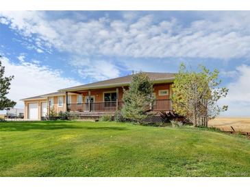 Ranch style home with spacious lawn and deck at 35100 E 120Th Ave, Hudson, CO 80642