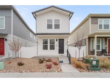 Two-story house with white siding, small front yard, and white picket fence at 4943 N Yampa St, Denver, CO 80249