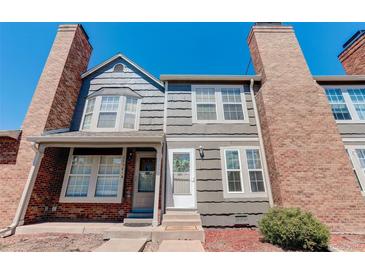 Brick and gray siding townhouse exterior with landscaping at 16941 E Chenango Ave # C, Aurora, CO 80015