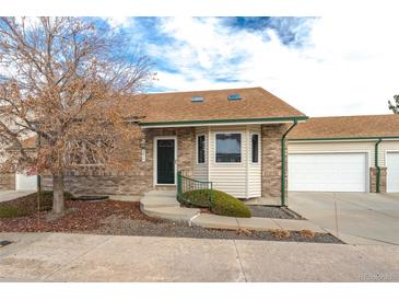 Brick front exterior of charming ranch-style home with attached garage at 2617 E Egbert St, Brighton, CO 80601