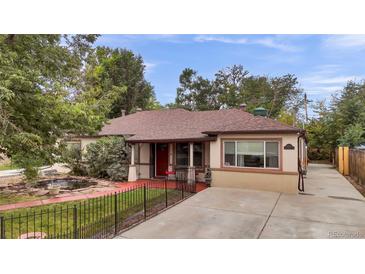 House exterior showcasing a charming ranch home with a landscaped yard at 1219 Tucson St, Aurora, CO 80011