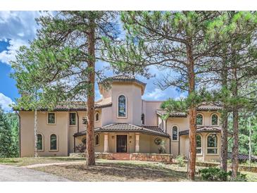 Two-story house with a grand entrance and landscaping at 26600 Mowbray Ct, Evergreen, CO 80439