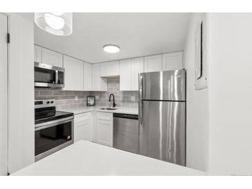 Modern kitchen with stainless steel appliances and white cabinetry at 17004 E Tennessee Dr # 210, Aurora, CO 80017