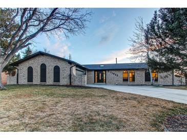 Beautiful brick ranch home with landscaped yard and large driveway at 11922 W 77Th Dr, Arvada, CO 80005