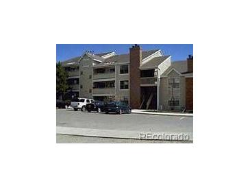 Exterior view of a multi-unit residential building with parking at 12093 W Cross Dr # 308, Littleton, CO 80127