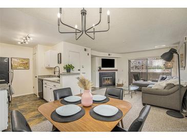 Bright dining area with a mid-century modern table and four chairs at 9510 E Florida Ave # 2052, Denver, CO 80247