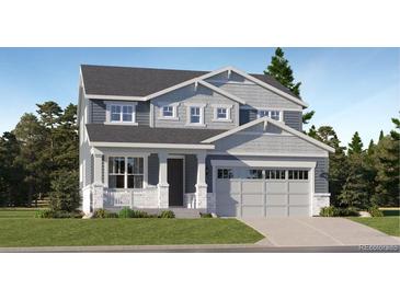 Two-story Craftsman home with gray siding, white trim, and a two-car garage at 564 Twilight St, Erie, CO 80516