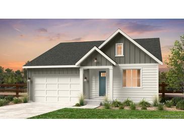 Charming two-story home with a blue front door, white siding, and a two-car garage at 16514 W 93Rd Way, Arvada, CO 80007