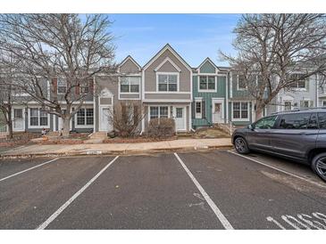 Gray townhome with two-toned siding and landscaping at 10681 W Dartmouth Ave, Lakewood, CO 80227