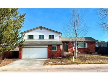 Brick ranch house with attached garage and landscaping at 6442 S Holland Ct, Littleton, CO 80123