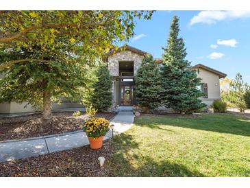 Two story house exterior with landscaping and walkway at 6297 Ellingwood Point Way, Castle Rock, CO 80108