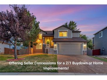 Two-story house with a landscaped yard, attached garage, and charming curb appeal at 17166 Yellow Rose Way, Parker, CO 80134