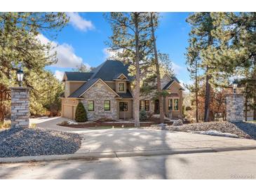 Two-story home with stone accents and a landscaped yard at 5440 Soapweed Cir, Parker, CO 80134