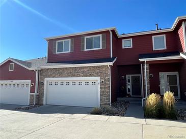 Modern two-story townhome with attached garage and stone accents at 12207 Stone Timber Ct, Parker, CO 80134