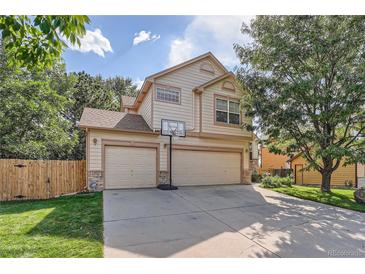 Two-story house with a three-car garage and basketball hoop at 18872 E Prentice Pl, Centennial, CO 80015