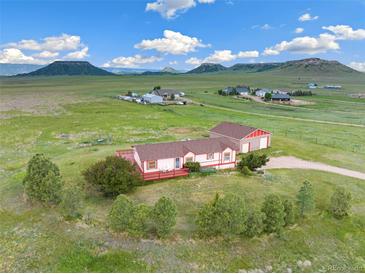 Aerial view of a ranch-style home with detached garage and expansive land at 12155 Mesa View Rd, Larkspur, CO 80118
