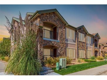 Two-story townhome with stone accents and landscaped grounds at 15195 E 16Th Pl # 204, Aurora, CO 80011