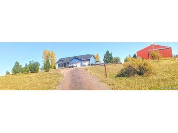 Blue house, red barn, and long driveway at 3188 S County Road 137, Bennett, CO 80102