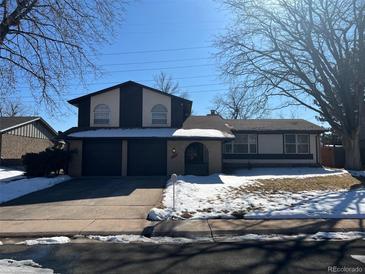 Two-story house with a two-car garage and landscaping at 11742 E Jewell Pl, Aurora, CO 80012