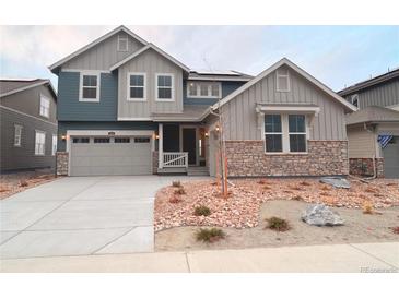 Two-story house with gray and blue siding, a two-car garage, and landscaping at 3763 Doubletrack Ln, Castle Rock, CO 80108