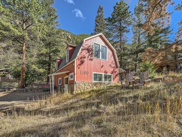 Red barn-style home with stone foundation at 1300 Main St, Georgetown, CO 80444