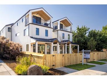 Two-story modern home with light-colored siding, wood accents, and a fenced yard at 1411 Zenobia St, Denver, CO 80204