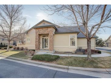 Exterior of charming ranch home with stone accents and landscaped yard at 6656 S Shawnee St, Aurora, CO 80016